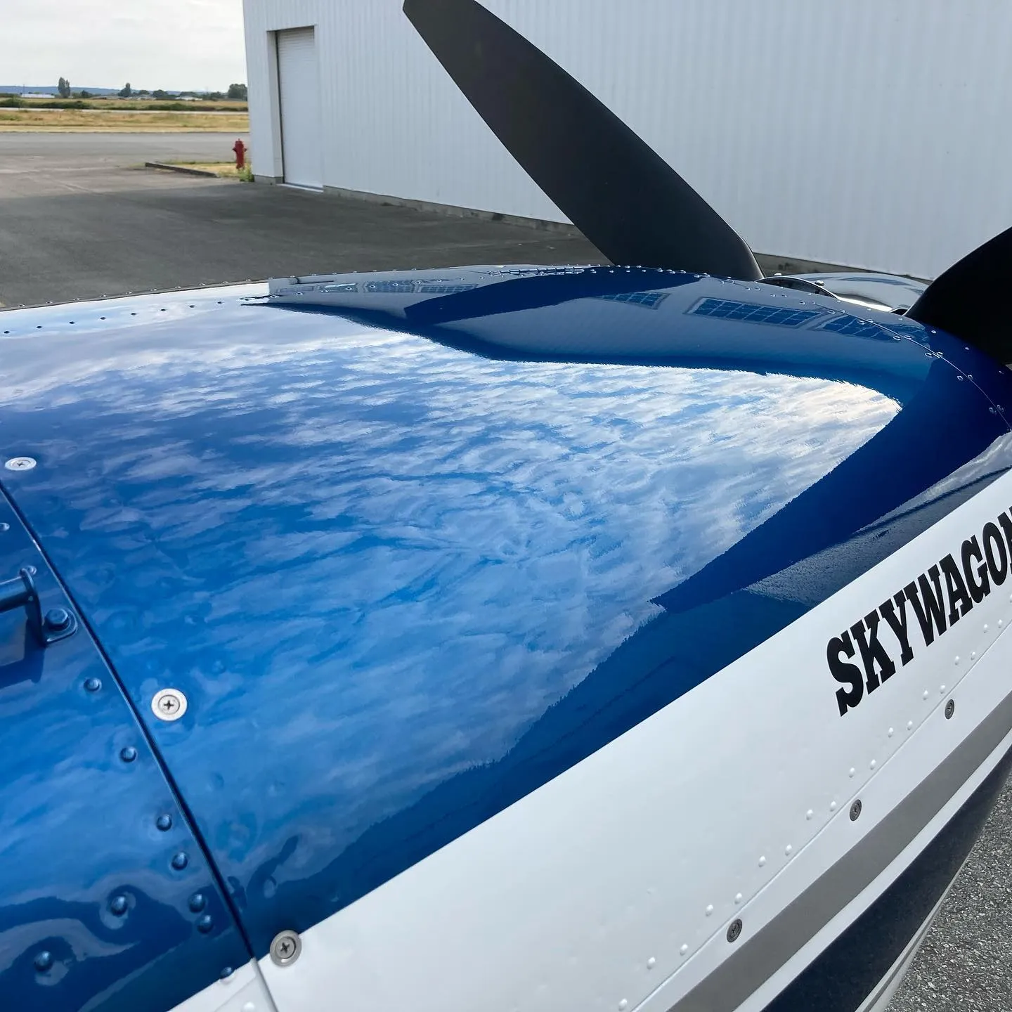 Sky reflected in a mirror-finish fuselage